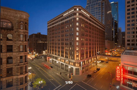 Budget hotels in Minneapolis at night with downtown city buildings and street view