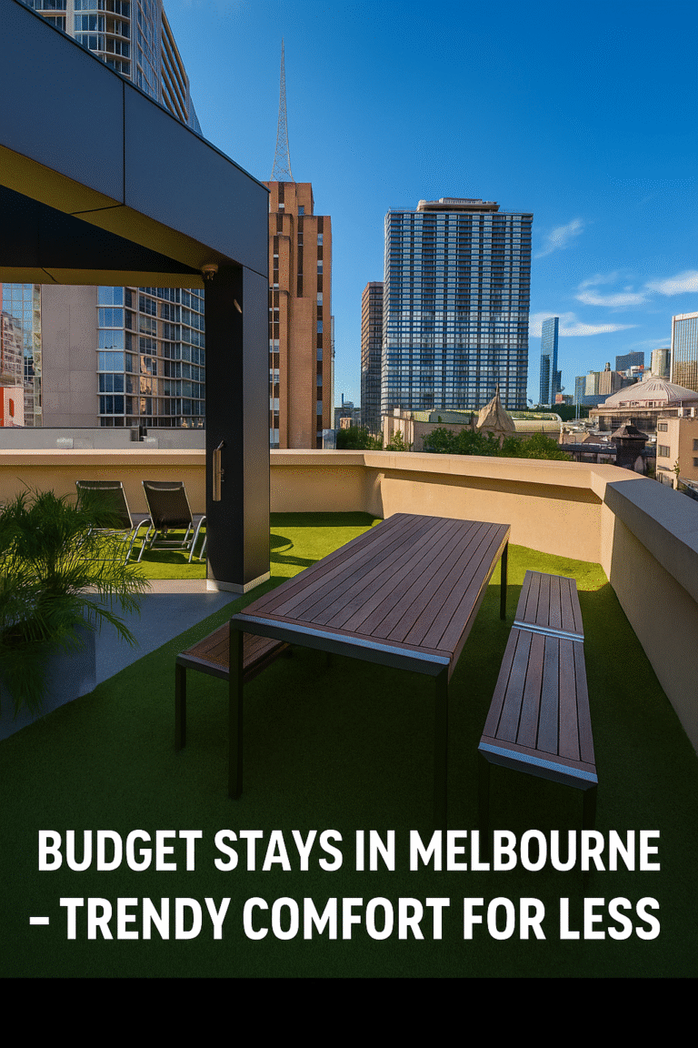 Rooftop terrace in Melbourne with a modern wooden table and benches, surrounded by city skyscrapers under a clear blue sky, promoting budget stays in Melbourne – trendy comfort for less.