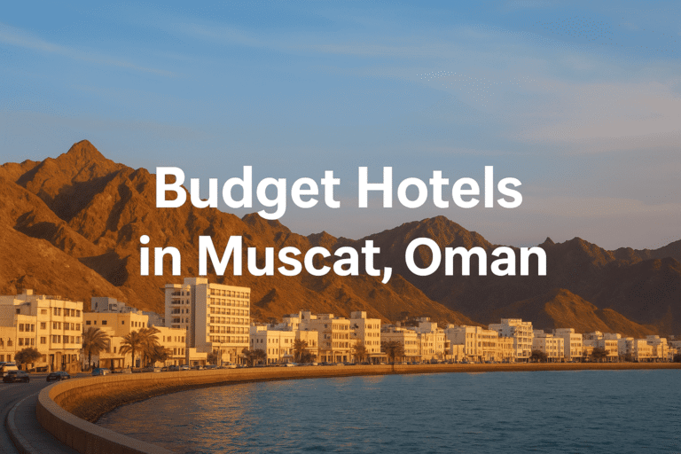 Scenic view of Muscat’s coastline with budget hotels and mountains in the background.