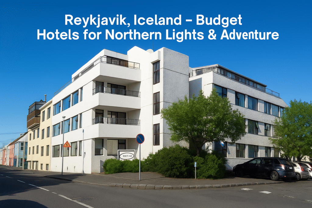 Modern budget hotel building in Reykjavik, Iceland, with white architecture, clear blue sky, and nearby trees — ideal stay for Northern Lights and adventure travelers